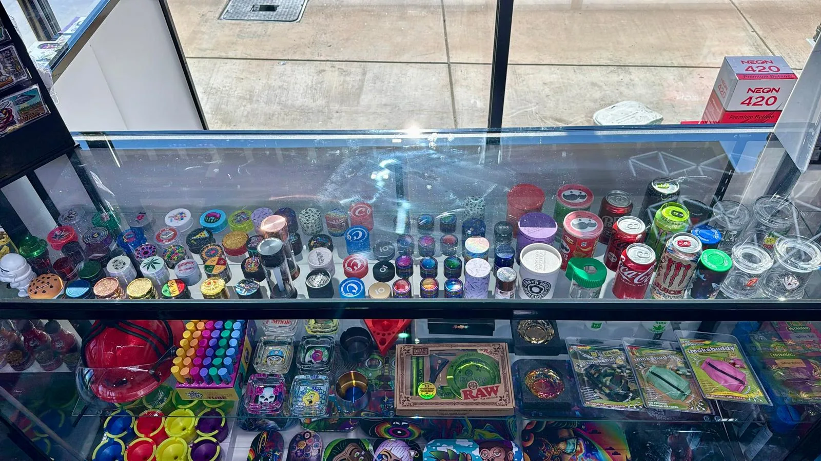 Grinders, papers and smoking accessories in the Vapex display case