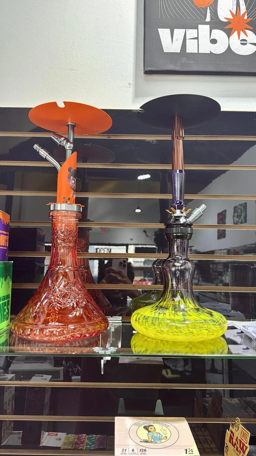 Modern hookahs displayed inside Vapex